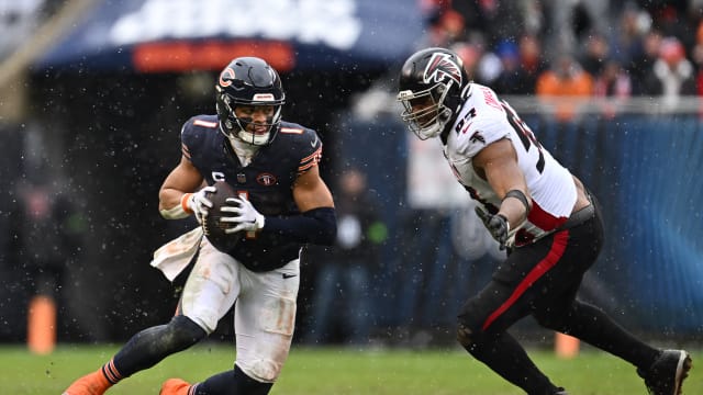 Dec 31, 2023; Chicago, Illinois, USA; Chicago Bears quarterback Justin Fields (1) scrambles away from Atlanta Falcons defensive lineman Calais Campbell (93) in the first half at Soldier Field.